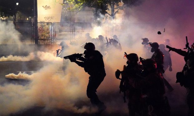 PORTLAND, OR - JULY 24: Federal officers deploy tear gas and less-lethal munitions while dispersing...