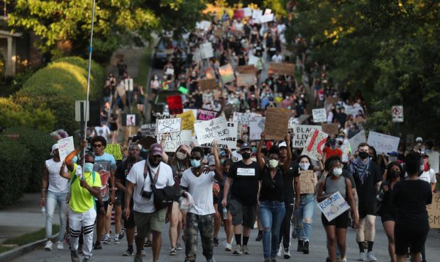 FILE: Demonstrators march through the streets against police brutality and racism on June 20, 2020 ...
