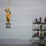 The angel Moroni and capstone being removed by a large crane with artisan journeyman viewing in the background as part of the ongoing renovation of the Salt Lake Temple, May 18, 2020. (Intellectual Reserve, Inc.)
