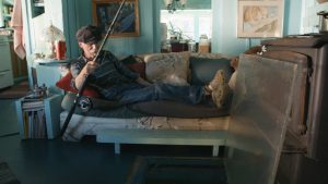 Thanks to a piece of Plexiglass in their living room, Adams is able to fish from the comfort of his couch.