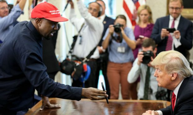 Rapper Kanye West , left, shows a picture of a plane on a phone to U.S. President Donald Trump duri...