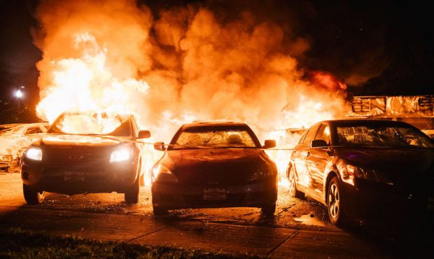 Cars are set on fire in a used car lot on August 24, 2020 in Kenosha, Wisconsin. This is the second...