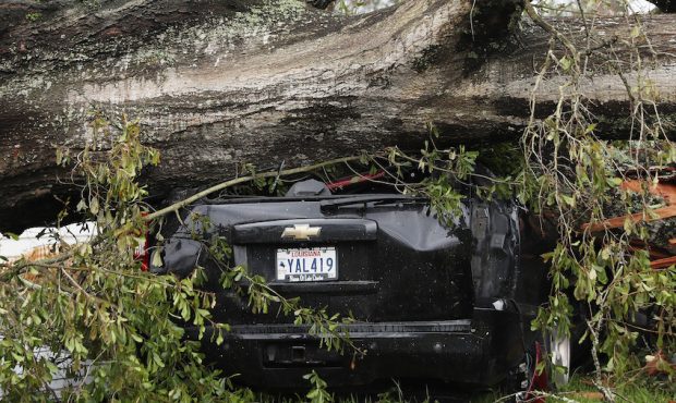 LAKE CHARLES, LOUISIANA - AUGUST 28: A vehicle is seen crushed under a tree after Hurricane Laura p...