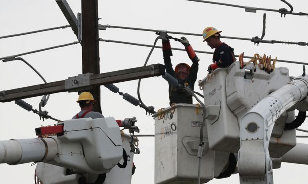 Workers with the Pike Electric company work on restoring electricity on August 28, 2020 in Lake Cha...