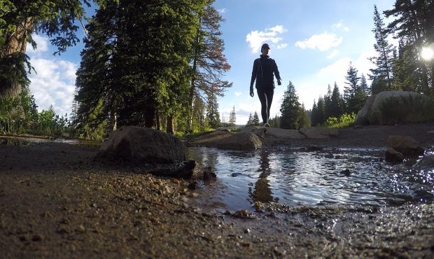 FILE: Megan Hansen crosses over a stream while hiking Lake Mary up Big Cottonwood Canyon....