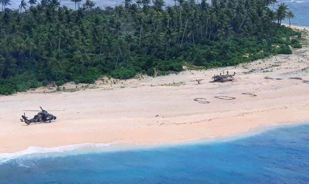 Three men from the Federated States of Micronesia on the beach of Pikelot Island, found after a com...