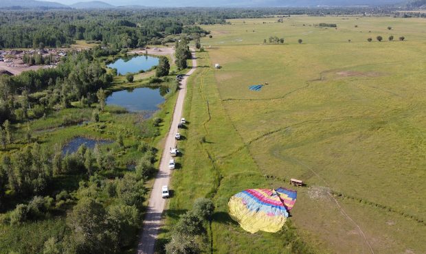 A pair of hot-air balloons lie in a field just south of Teton Village — about six miles northwest...