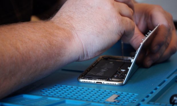 Tech MD owner Dustin Knight repairs a smartphone....
