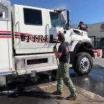 Crews were busy Saturday morning cleaning their trucks and equipment after returning home from a three-week rotation, fighting wildfires in California.
