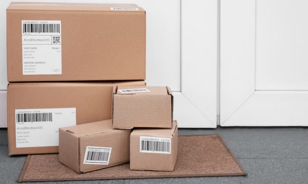 Delivered parcels on floor near front door. (Adobe Stock)...
