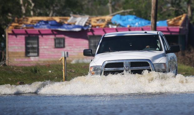 LAKE CHARLES, LOUISIANA - OCTOBER 10: A truck drives through flood waters from Hurricane Delta in a...
