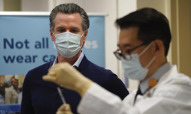 Gov. Gavin Newsom watches as the Pfizer-BioNTech COVID-19 vaccine is prepared
by Director of Inpati...