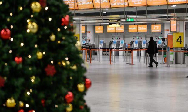 A person walks past the Christmas tree in the near-empty North Terminal at Gatwick Airport on Novem...