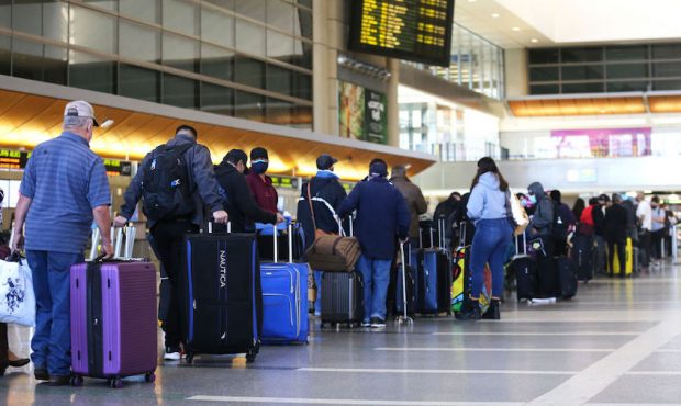 Travelers wait in line to check in for a flight at the Tom Bradley International Terminal at Los An...