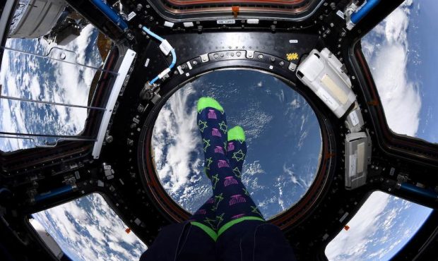Meir showed off her Hannukah socks in the cupola. (NASA)...