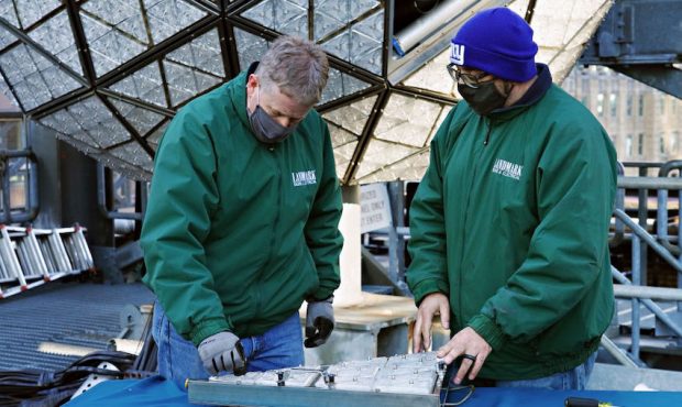 Workers install 192 new 'Gift of Happiness' Waterford Crystal triangles on the Times Square New Yea...