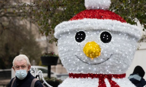 A member of the public walks past a snowman Christmas decoration on November 27, 2020 in Royal Tunb...