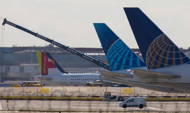 The tail fins of a passenger aircraft, operated by United Airlines Holdings Inc., sit on the tarmac...