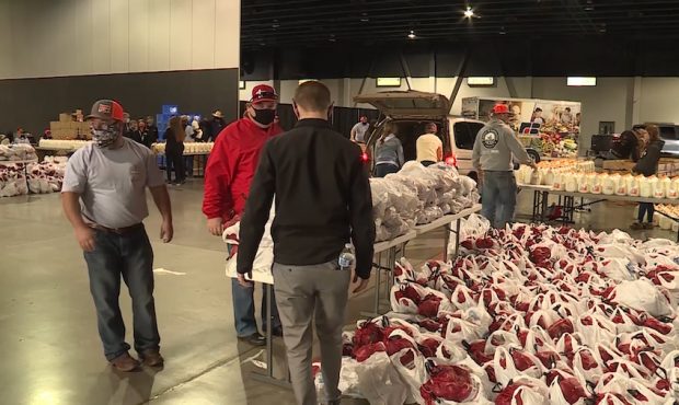 Volunteers help distribute food during a Farmers Feeding Utah event in St. George on Jan. 29, 2021....