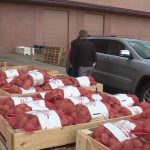 Volunteers help distribute food during a Farmers Feeding Utah event in St. George on Jan. 29, 2021. (Marc Weaver/KSL-TV)