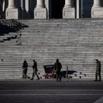WASHINGTON, DC - JANUARY 07: Police officers survey the damage and debris left on the Eastern steps of the U.S. Capitol Building on January 7, 2021 in Washington, DC. Following a rally yesterday with President Donald Trump on the National Mall, a pro-Trump mob stormed and broke into the U.S. Capitol causing a Joint Session of Congress to delay the certification of President-elect Joe Biden's victory over President Trump. (Photo by Samuel Corum/Getty Images)