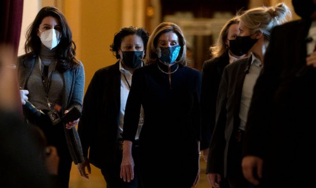 Speaker of the House Nancy Pelosi (D-CA) (C), surrounded by a security detail, walks to her office ...