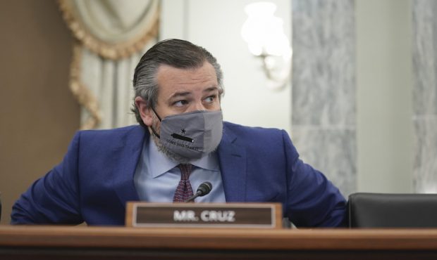 FILE - Sen. Ted Cruz, a Republican from Texas, wears a protective mask while arriving to a Senate C...