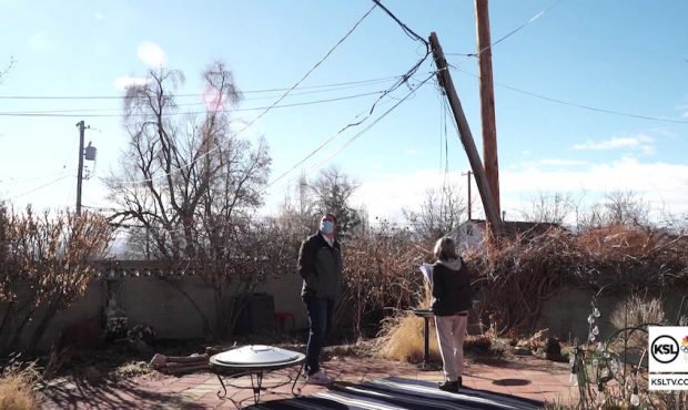 A broken power pole stands precariously in the backyard of Michelle's Avenues home. (KSL-TV)...