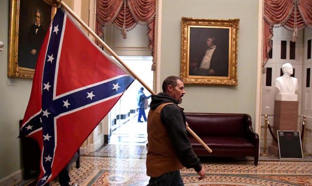 Kevin Seefried carries a Confederate battle flag on the second floor of the U.S. Capitol after brea...