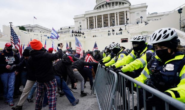 Trump supporters try to break through a police barrier, Wednesday, Jan. 6, 2021, at the Capitol in ...