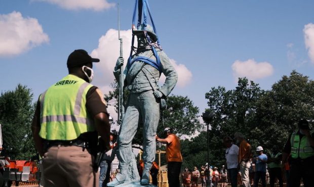 Workers inspect the Confederate soldiers and sailors statue on July 8, 2020 in Richmond, Virginia. ...