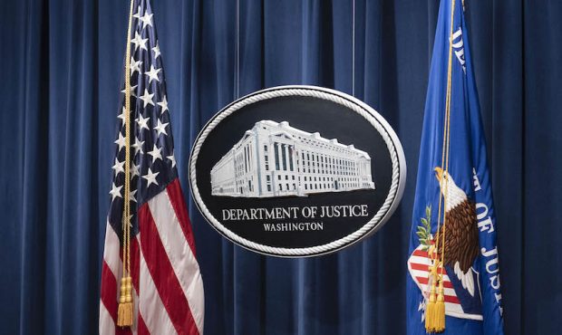 A sign for the Department of Justice is seen before Steven D'Antuono, FBI Washington field office A...