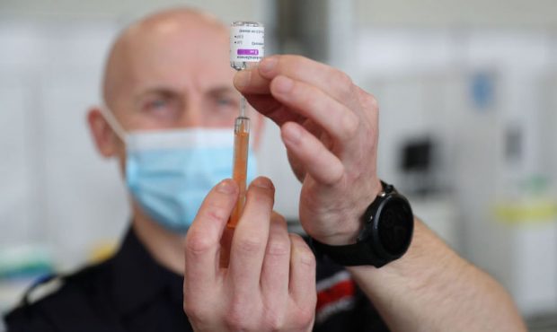 A dose of the Oxford/AstraZeneca coronavirus vaccine is prepared by a member of the Hampshire Fire ...