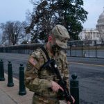 Members of the National Guard walk by the fenced perimeter that surrounds the U.S. Capitol in the early morning February 10, 2021 in Washington, DC. House managers and the defense will make opening arguments today as the Senate impeachment trial of former President Donald J. Trump continues. (Photo by Sarah Silbiger/Getty Images)
