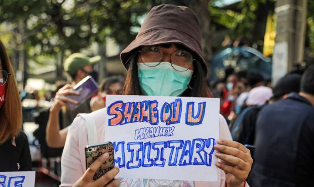 A protester holds up a sign condemning Myanmar's military at a protest outside Myanmar's embassy on...