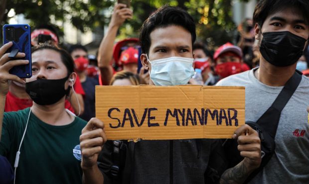 A protester holds up a sign that reads "Save Myanmar" outside Myranmar's embassy on February 01, 20...