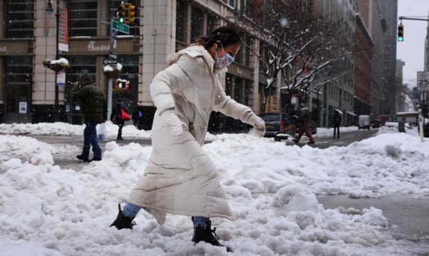 People walk through the snow in Manhattan on February 02, 2021 in New York City. New York City and ...