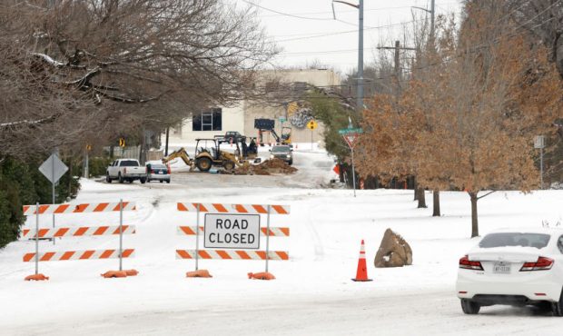 Drivers detour around a water pipe repair crew after a snow storm on February 18, 2021 in Fort Wort...