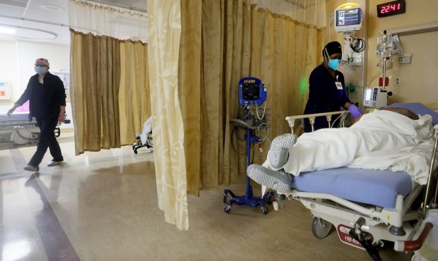 A clinician cares for a patient in a COVID-19 isolation area at Providence St. Mary Medical Center ...