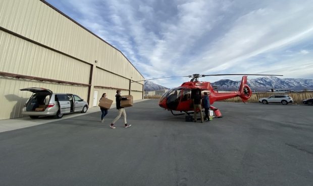 Volunteers prepare for a helicopter flight to deliver supplies to a remote community in Arizona. (P...