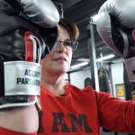 Jennifer Christ shows off her boxing gloves which read "Fight Back" on the outside and "Against Parkinson's" on the inside of the glove. (Photo: KSL TV)