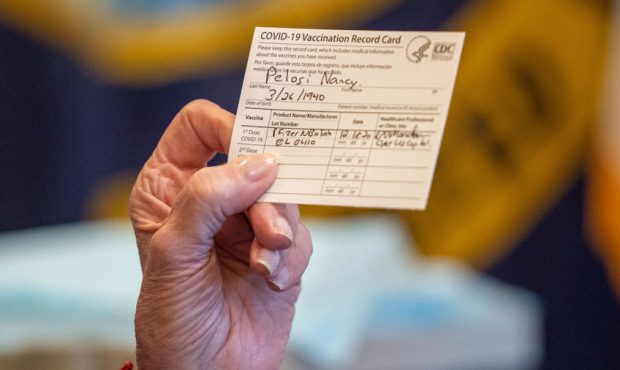 FILE: Speaker of the House Nancy Pelosi (D-CA) holds up a Vaccination Record Card after receiving a...