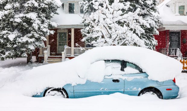 A car sits buried in snow on March 14, 2021 in Denver, Colorado. More than 1800 flights into and ou...