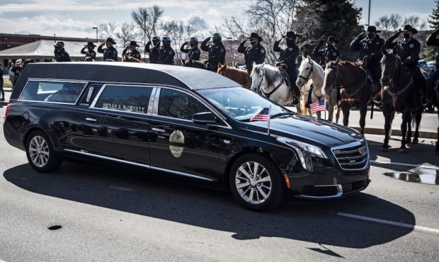 A hearse carrying slain Boulder Police officer Eric Talley makes its way into Flatirons Community C...