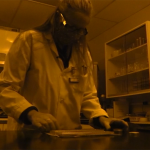 Tammy Rittenour examines soil samples in her dark lab which manipulated the colors in this photo. (KSL TV)