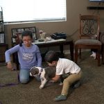 Elizah and Saul Ocampo play with their new, three-month old puppy, Luna. (Photo Credit: KSL TV)