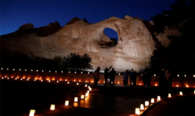 The Window Rock formation is illuminated on March 17 in Window Rock, Arizona during an event to rem...