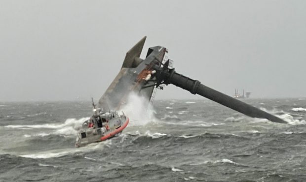 A Coast Guard Station Grand Isle 45-foot Respone Boat-Medium boatcrew heads toward a capsized 175-f...