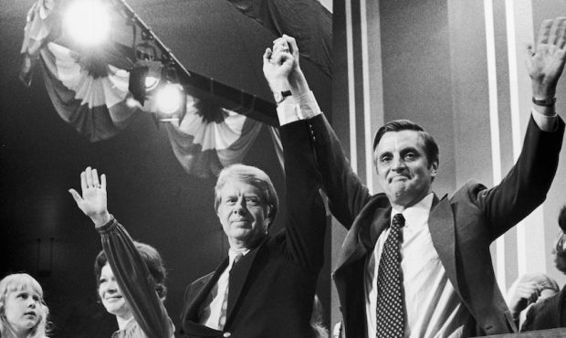 Democratic Presidential nominee Jimmy Carter raises hands with Vice Presidential nominee Walter Mon...