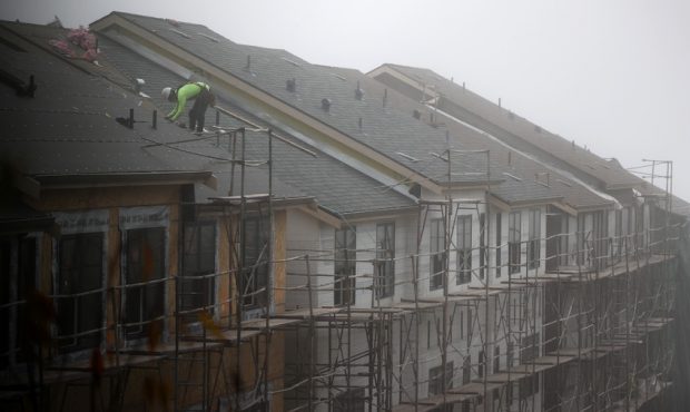A worker stands on the roof of a new home under construction on September 24, 2020 in South San Fra...